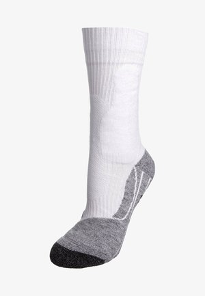 Calzino bianco e grigio con bordo a coste, soletta imbottita e tallone rinforzato. Il materiale sembra traspirante con la punta nera a contrasto.