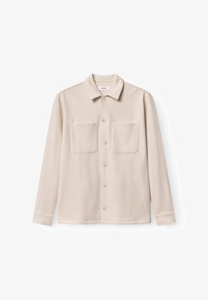 Beige lange mouwen shirt gemaakt van gestructureerde stof met een kraag, twee voorkanten zakken en knoopsluiting. Zacht, casual ontwerp.
