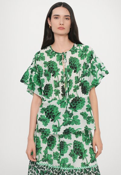 Green floral print blouse with short ruffled sleeves, a keyhole tie neck closure, and a lightweight fabric featuring distinct leaf patterns.