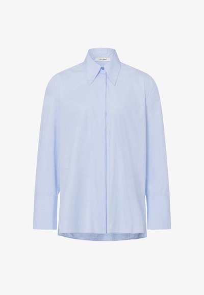 Light blue, long-sleeve button-up shirt made of smooth fabric, featuring a pointed collar and a straight hem, with a relaxed fit.