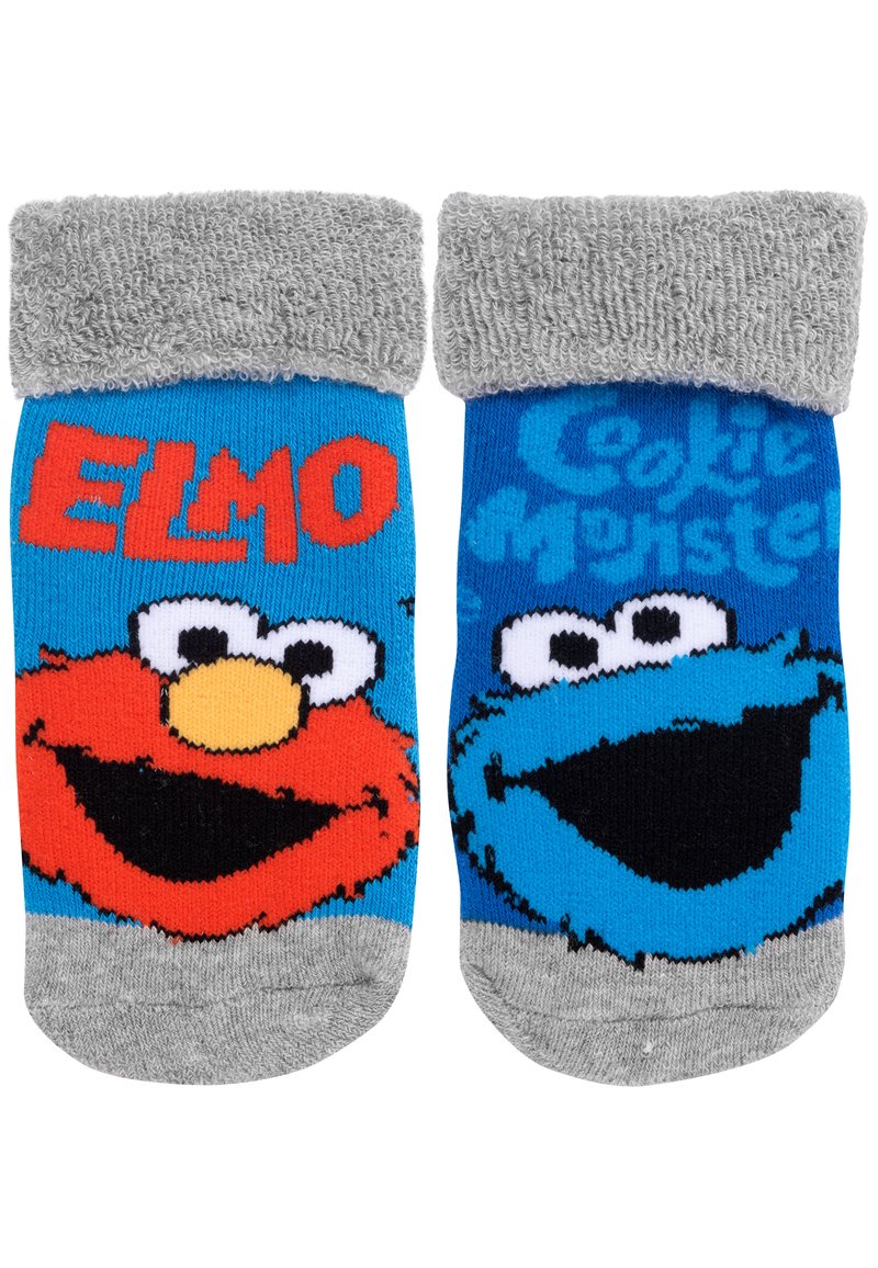 Calzini per bambini con i personaggi Elmo e Cookie Monster. Realizzati in tessuto a maglia, nei colori rosso e blu, con dettagli in terry grigio sul polsino.