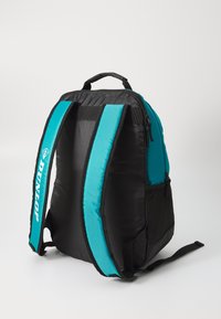 Dunlop-Rucksack in Schwarz mit türkisfarbenen Akzenten, ausgestattet mit gepolsterten Schultergurten, einer Reißverschlusstasche und einer strukturierten Stoffoberfläche.