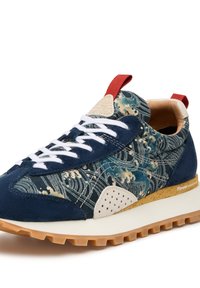 Blue and beige sneaker with a wave pattern, suede and textile upper, red accent, white laces, and a textured gum sole.