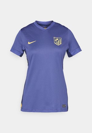Maillot de football violet avec un col en V, manches courtes, présentant un logo Nike jaune et un écusson d'équipe à rayures multiples sur la poitrine.