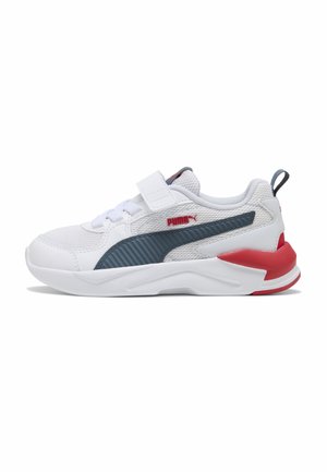 White Puma sneaker with navy stripe, red accents, mesh upper, hook-and-loop strap, and cushioned sole, shown in side view.