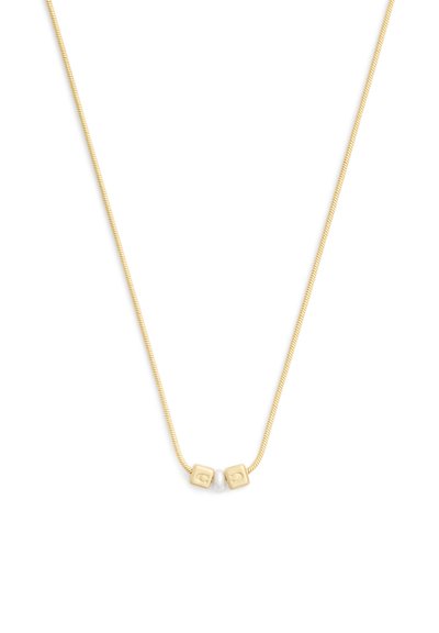 Collier délicat en chaîne d’or avec deux petites perles carrées en or et une perle blanche disposées au centre sur un fond blanc.