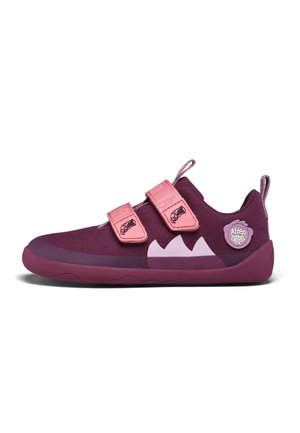 Purple athletic shoes with two pink Velcro straps, rounded toe, textured fabric upper, rubber sole, and a logo patch on the heel.