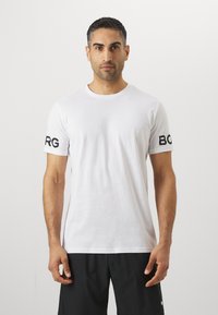 Hvit bomull t-skjorte med korte ermer. Svart tekst "BORG" trykket på den ene ermen. Klassisk rund hals-design. Glatt tekstur, tettsittende fasong.
