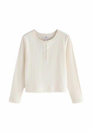 Top scurt cu mânecă lungă dintr-o țesătură ribbed de culoare albă. Are un guler rotund și trei butoane în față. Textură moale și croi lejer.