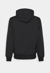 Black hooded jacket featuring elastic cuffs and waistband, made from a smooth, water-resistant material with no visible logos or patterns.