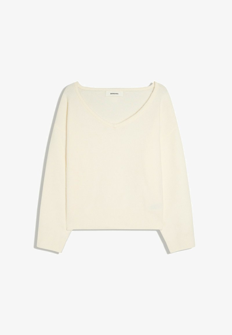 Pull crème à manches longues avec col en V et ourlet droit, présenté à plat sur fond blanc.