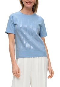 Light blue short-sleeve t-shirt made of soft fabric, featuring a sequined vertical pattern across the front and a straight hem.