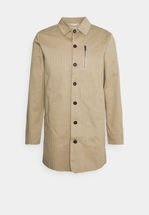 Beige cotton blend coat with a straight cut, featuring a spread collar, front button closure, and a zippered chest pocket.