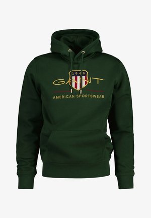 Green hooded sweatshirt made of cotton with a front pocket and ribbed cuffs. Features a logo with red, white, and blue accents and gold text.