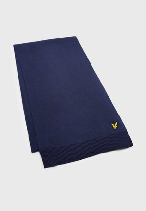 Écharpe en tricot bleu marine avec des extrémités côtelées et un petit logo jaune. Fabriquée en matériau doux, elle présente un design rectangulaire simple et élégant.