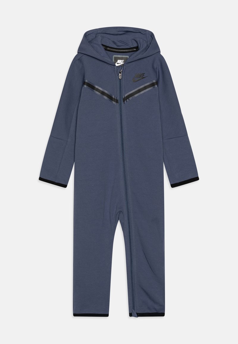 Navy blue zip-up onesie with hood, featuring black stripe accents, elastic cuffs, and Nike logo on the chest; made of a soft, stretchy material.