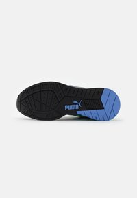 Black outsole with blue and green accents, textured pattern for grip, features the Puma logo prominently in blue on the side.