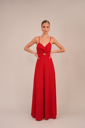 Red maxi dress made of smooth fabric with thin straps, featuring a twisted front detail and cutout at the waist. Floor-length design.