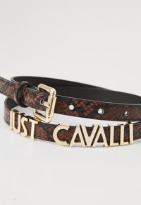 Brown faux snake leather belt featuring a shiny gold-tone buckle and bold "JUST CAVALLI" lettering in three-dimensional style.
