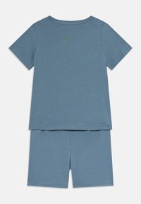 Blauwe katoenen T-shirt met korte mouwen en ronde hals, gecombineerd met bijpassende blauwe shorts. Beide items hebben een gladde textuur en een eenvoudig ontwerp.