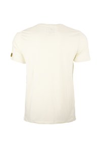 Cremefarbendes Baumwoll-T-Shirt mit kurzen Ärmeln, rundem Halsausschnitt und einem kleinen Aufnäher am linken Ärmel mit dem Markenlogo. Schlichtes Rückendesign.