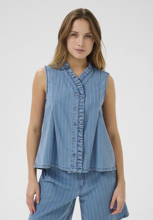 Denim sleeveless shirt featuring a ruffled button placket, vertical blue and white stripes, and a relaxed fit. Smooth texture, casual design.
