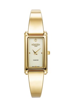 Montre rectangulaire dorée avec un accent en diamant sur un cadran texturé doré clair. Bracelet en métal à maillons avec une surface lisse. Fabriquée en Suisse.