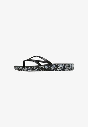Black flip-flop with textured straps. The sole features a white floral pattern on a black background. Thin design, lightweight construction.