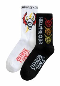 Sorte og hvide bomuldscrew-sokker med kranie- og dæmonmotiver, med "Stranger Things" og "Hellfire Club" trykt i kontrastfarver.