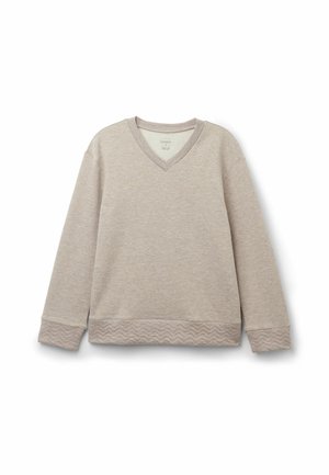 Ljust beige långärmad tröja med V-hals, texturerade ärmslut och en vågig mönstrad nederkant. Tillverkad av mjukt tyg, har en avslappnad passform.