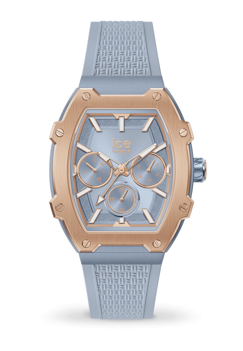 Orologio in silicone blu con quadrante geometrico, dettagli in oro rosa e tre sottodial. Cinturino testurizzato e indicatori di tempo chiari.
