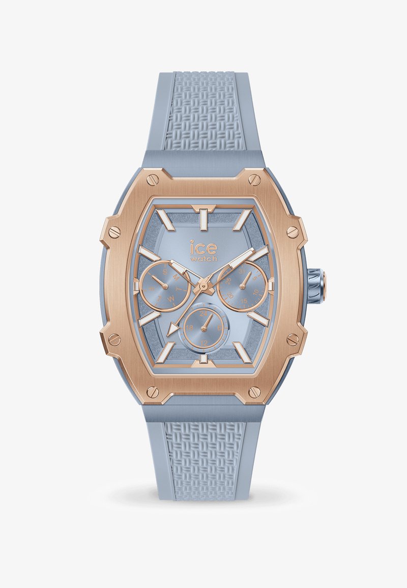 Niebieski zegarek z silikonu o geometrycznej tarczy, z różowymi złotymi akcentami i trzema subtarczami. Posiada teksturowany pasek oraz wyraźne znaczniki czasu.