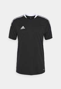 Černý sportovní dres Adidas s krátkým rukávem, bílým límečkem a pruhy na ramenou, logo Adidas na hrudi a štítek Aeroready blízko lemu.