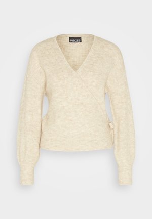 Cardigan in maglia beige con scollo a V, maniche lunghe e dettaglio annodato sul lato. Tessuto morbido e design leggero per il massimo comfort.