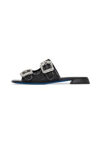 Black slide sandals with two large jewel-embellished buckles. Flat sole featuring a blue accent. Textured upper material with a smooth finish.