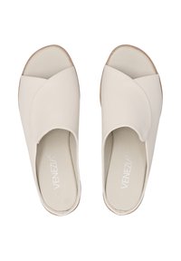 Beige slip-on sandals with crossover design, smooth leather texture, open toe, and a flat sole. Features embossed brand logo inside.