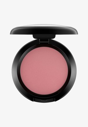 Compact rotondo nero con una finitura liscia, contenente un blush rosa tenue con una texture finemente rigata sulla superficie.
