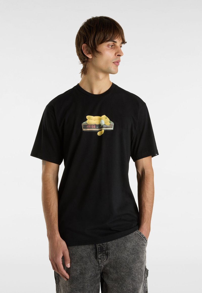 Black cotton t-shirt featuring a graphic of a yellow teddy bear on a digital clock. Short sleeves, casual fit, plain back.
