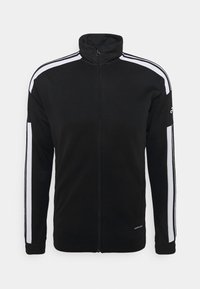 Chaqueta deportiva negra con cremallera y cuello alto, rayas blancas a lo largo de los hombros y las mangas, y texto "Aeroready" cerca del dobladillo.