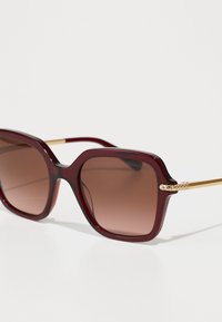 Swarovski Ochelari de soare - transparent burgundy