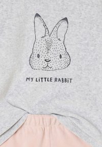 Light gray short-sleeve shirt with a black and white rabbit graphic. Text underneath reads "MY LITTLE RABBIT." Soft fabric, casual design.