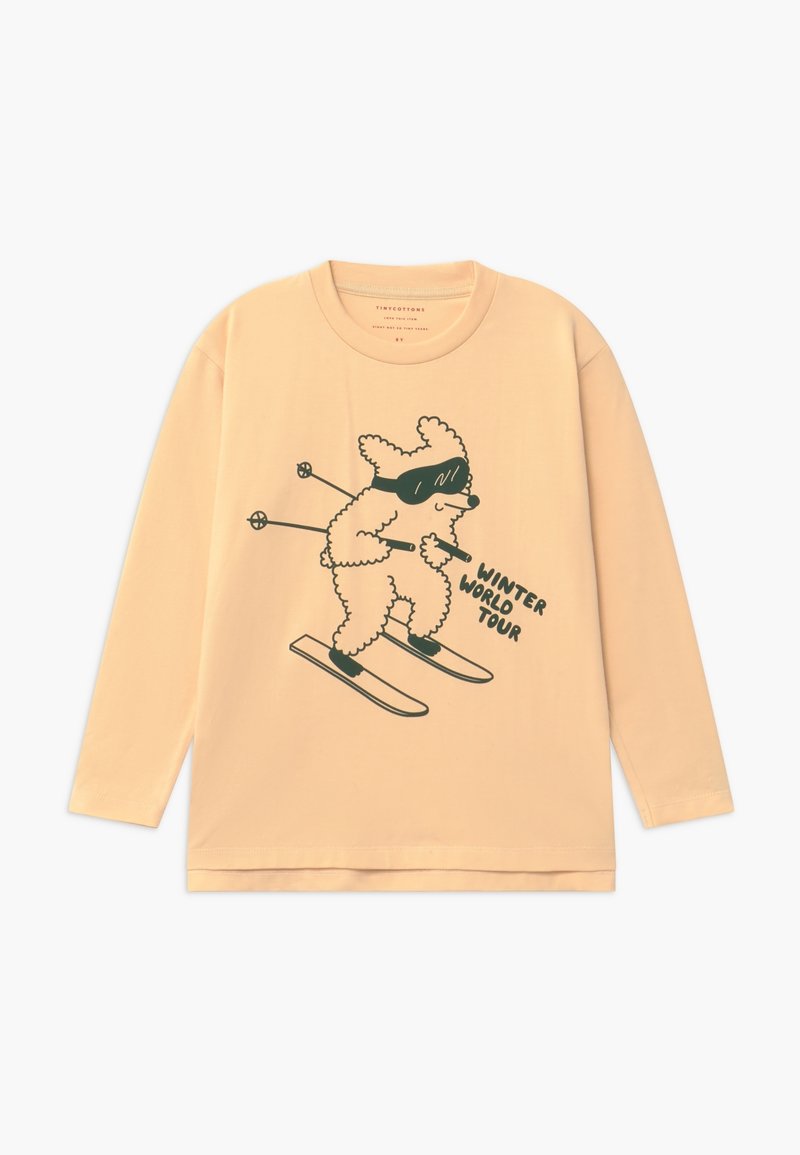 Chemise beige à manches longues avec un dessin au trait noir d'un chien skieur portant des lunettes et le texte « Winter World Tour. »