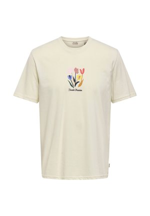 Vaaleanbeige lyhythihainen puuvillapaita. Koristeltu pehmeävärisellä kukkakuviolla, jonka alla teksti "Jardin Parisien".