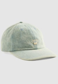 Light blue denim baseball cap with Levi's logo embroidered in beige on front, featuring six-panel construction and ventilation eyelets.