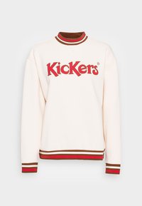 Felpa crema con logo rosso "Kickers". Presenta un colletto e polsini a righe marroni e rosse, con corpo e orlo in tinta unita.