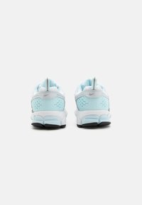Sport shoes featuring a breathable mesh upper in light blue with white accents, padded collar, reflective logo, and textured heel detail.