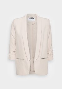 Beżowy marynarka o gładkiej teksturze, z otwartym przodem i podwiniętymi rękawami. Posiada dwie przednie kieszenie z delikatnym czarnym wykończeniem na krawędziach.