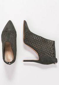 Szare zamszowe botki za kostkę z ażurowym wzorem w kratkę, wąskim noskiem i szpilką. Wyposażone w zamek błyskawiczny z tyłu.