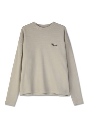 Beige langærmet skjorte i en struktureret vaffelstrik med rund halsudskæring og broderet "Pegador" logo på venstre bryst.