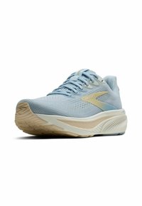 Zapatilla de correr azul claro con una parte superior de malla texturizada y una entresuela de color crema. Presenta una puntera redondeada y acentos laterales reflectantes.